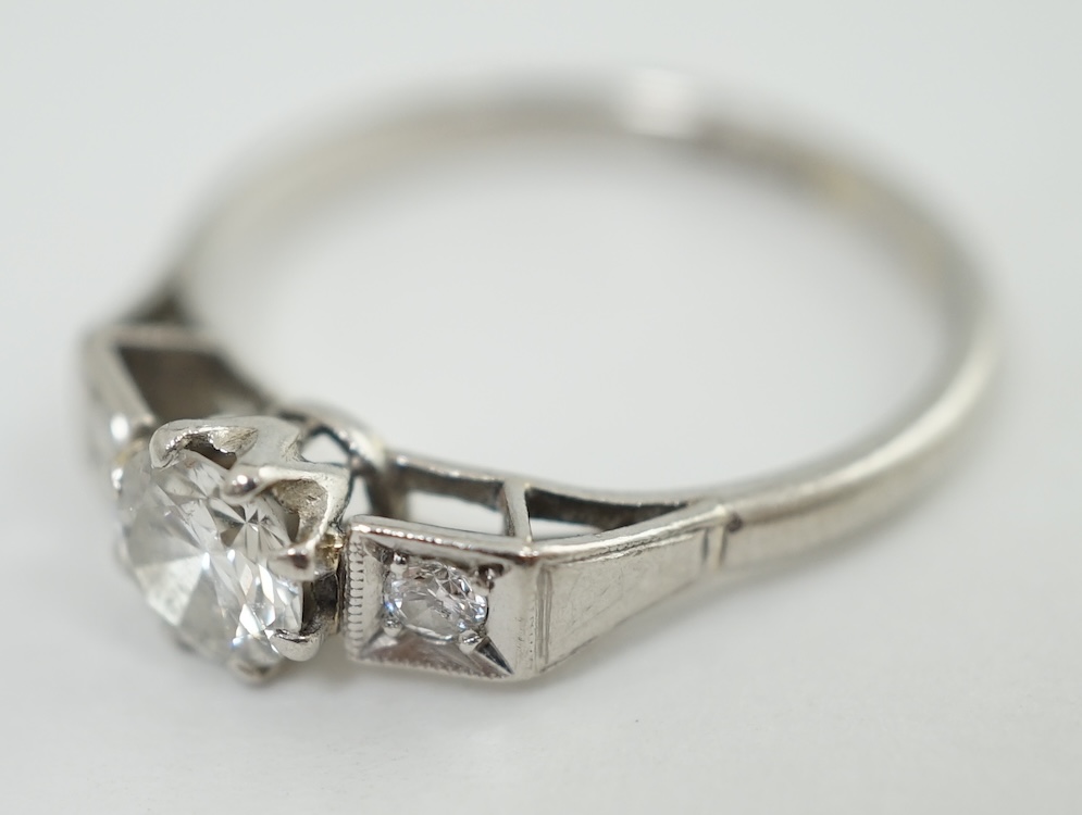 A 1920's/1930's platinum and single stone diamond set ring, with two stone diamond set shoulders